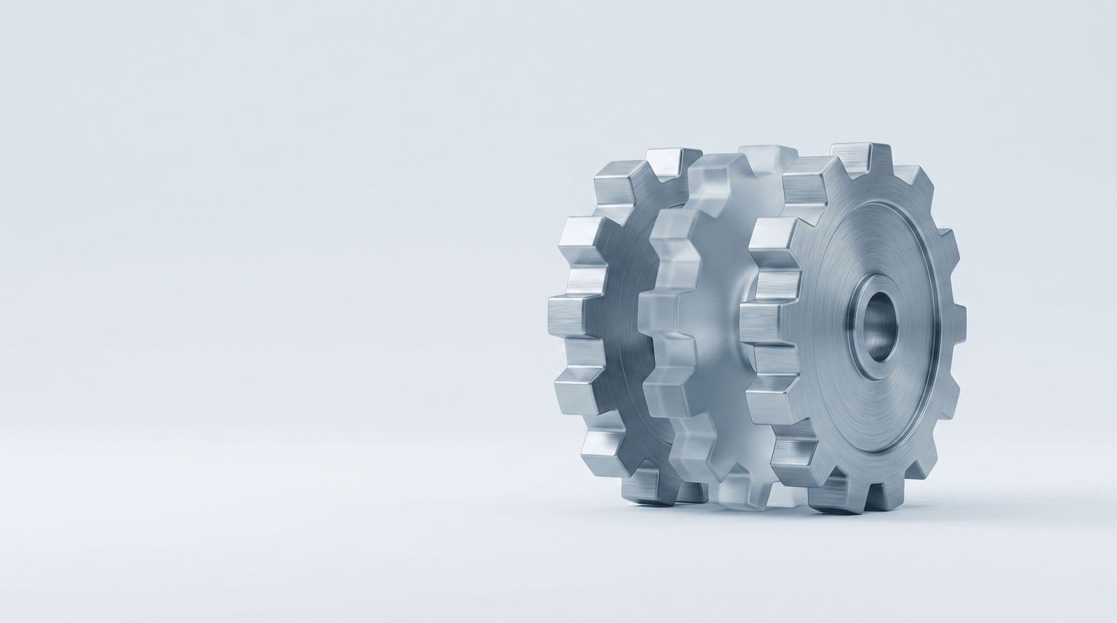 Three interlocking gears, the middle one made of frosted glass