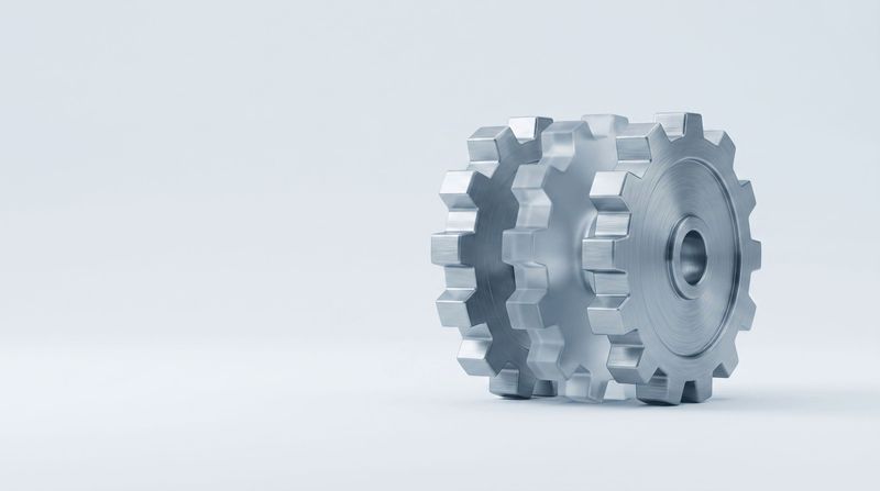 Three interlocking gears, the middle one made of frosted glass