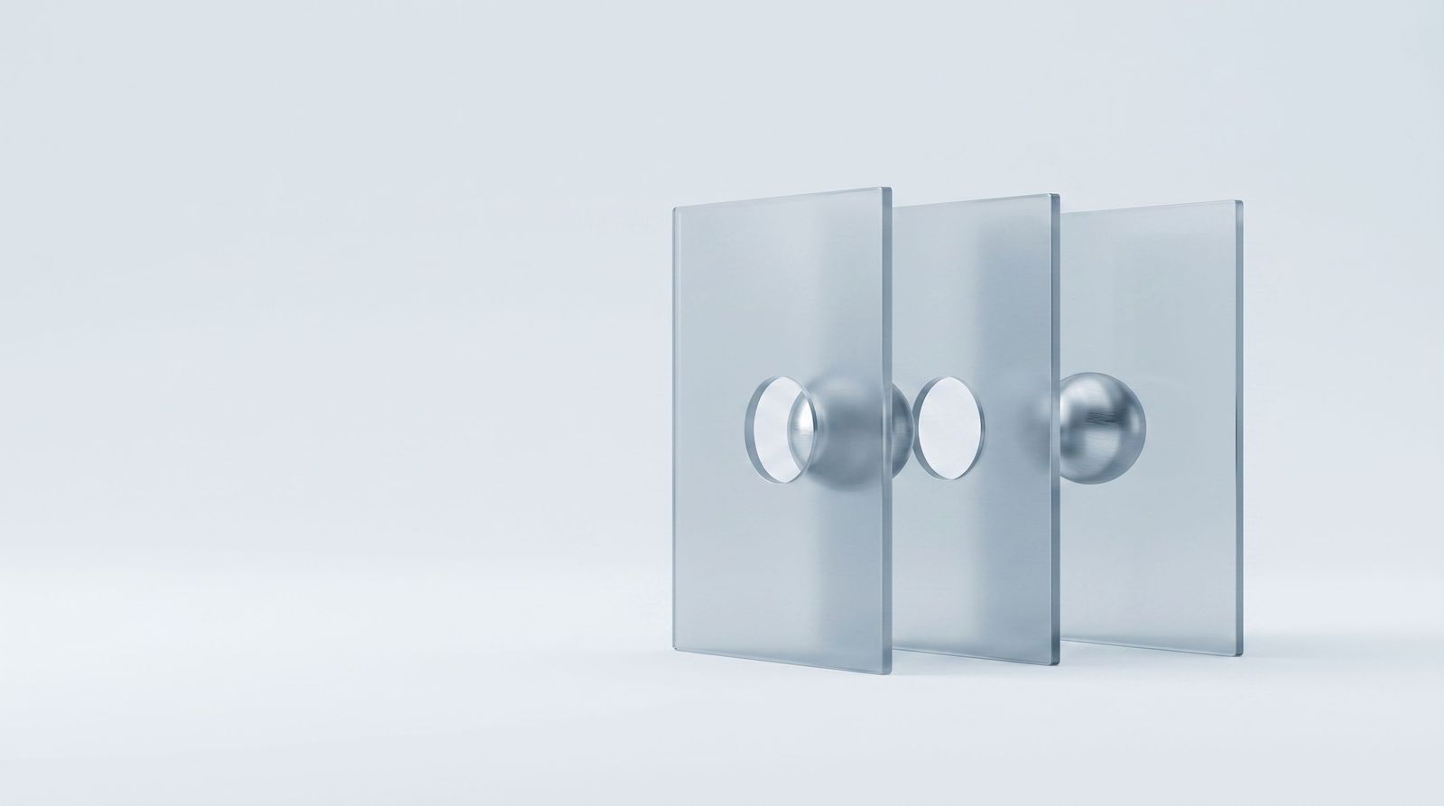 A steel sphere that has passed through two glass panels and stopped at a third