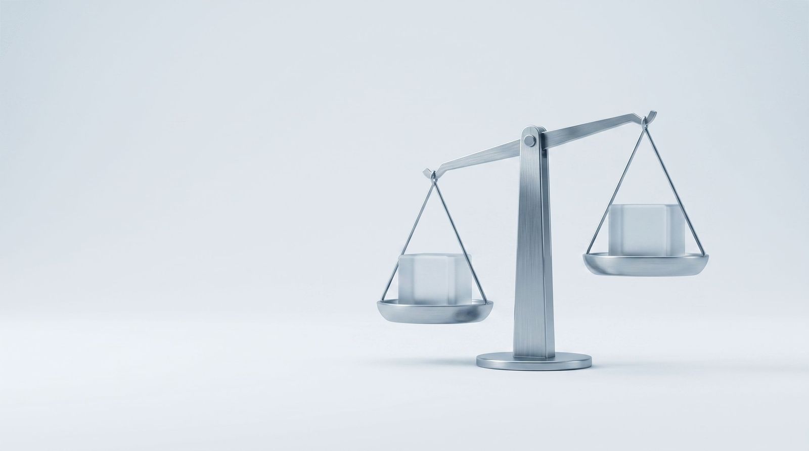 A steel balance scale holding a frosted glass cube on each pan