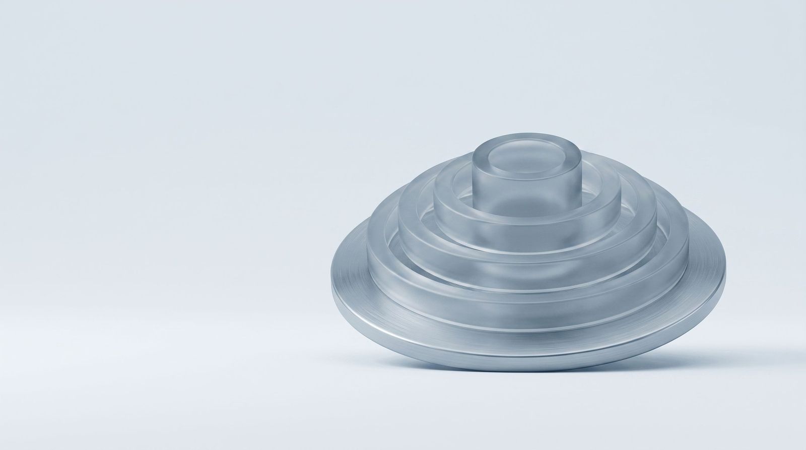 A steel disc with concentric glass rings rising from it like a contour map