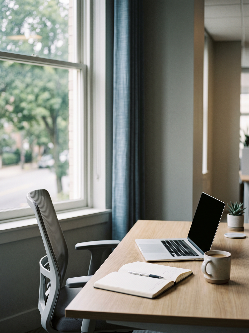 A calm account-manager workspace by a window